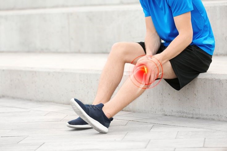 Person experiencing knee pain while climbing stairs and struggling with daily movement activities.